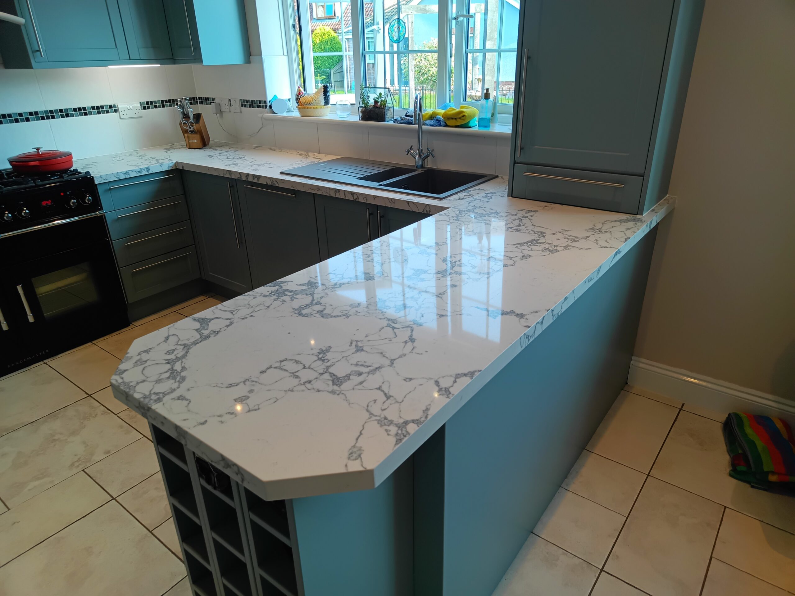 Great Yarmouth kitchen with Bulgaria Dark quartz overlay worktops after installation