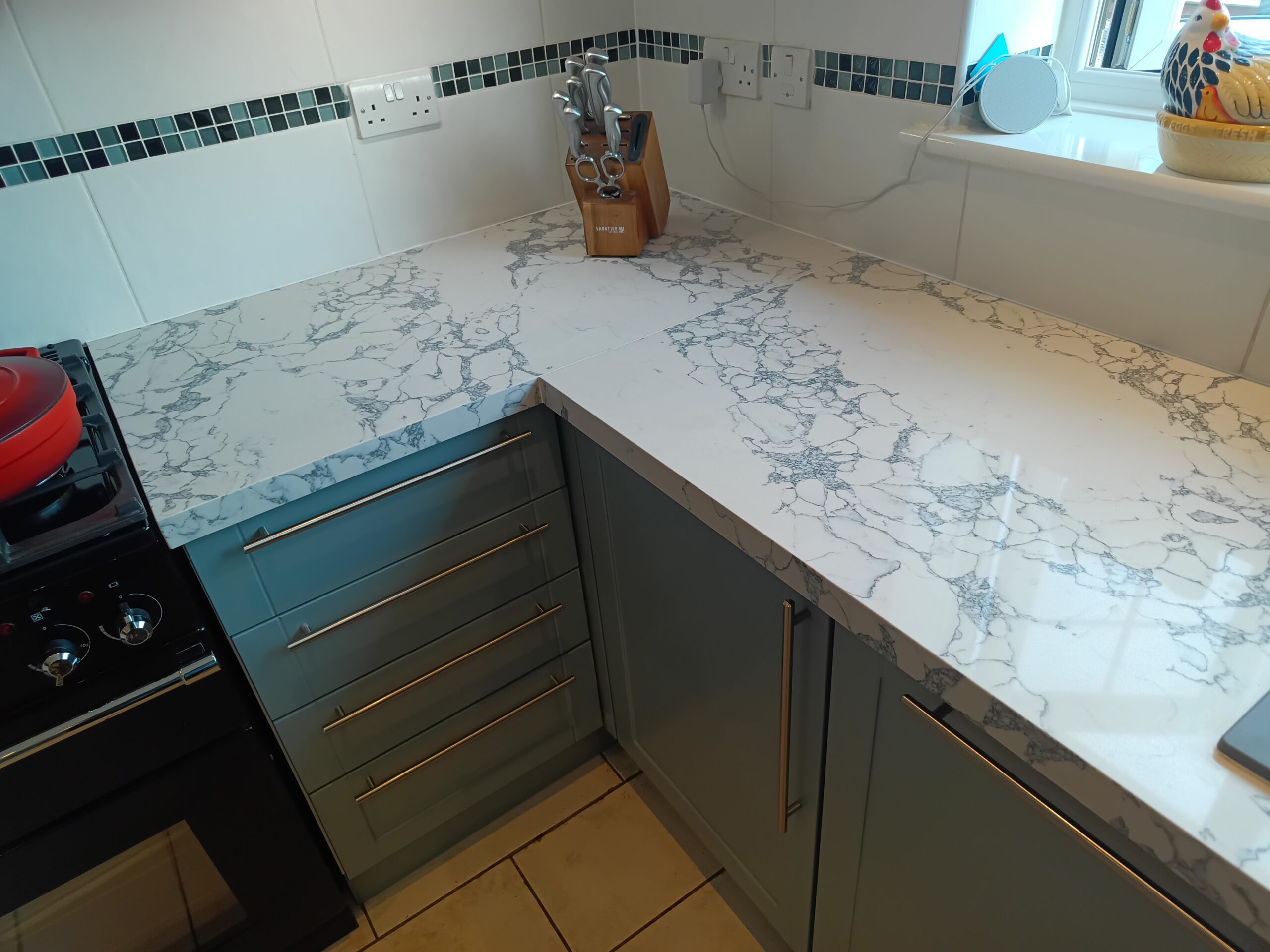 Great Yarmouth kitchen with Bulgaria Dark quartz overlay worktops after installation