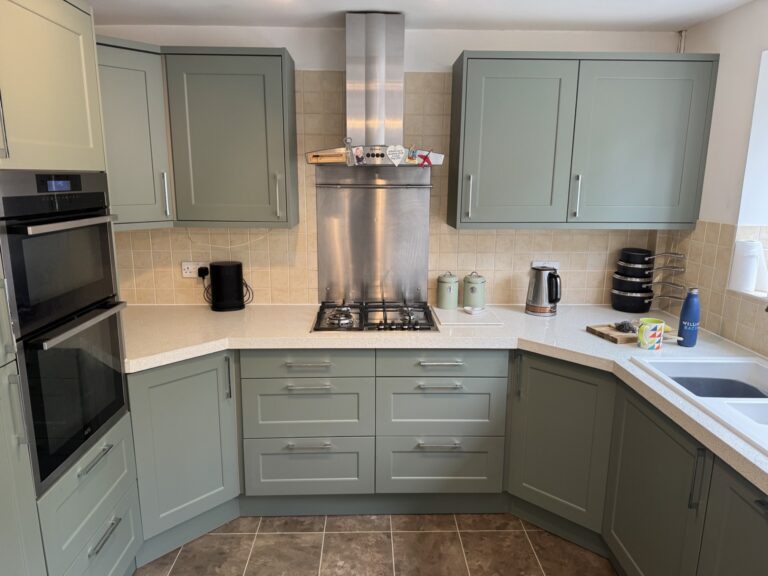 Modern Fareham kitchen with Horton Matt Reed Green doors and Carrara Gold quartz worktops after transformation