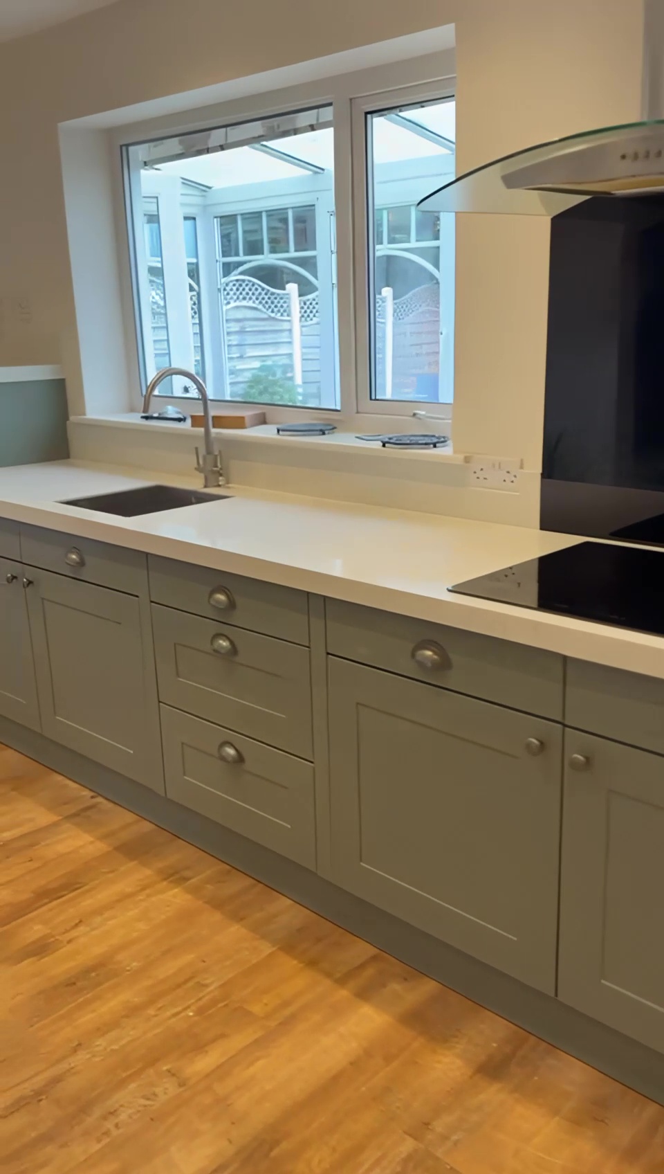 Modern Wakefield kitchen with Cologne Reed Green doors and White Sparkle quartz worktops after transformation